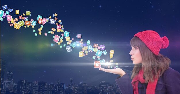 young woman with hat blowing application icons from her hands in front of the city at night